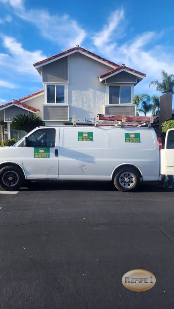 Repipe1 service van parked in front of a house.