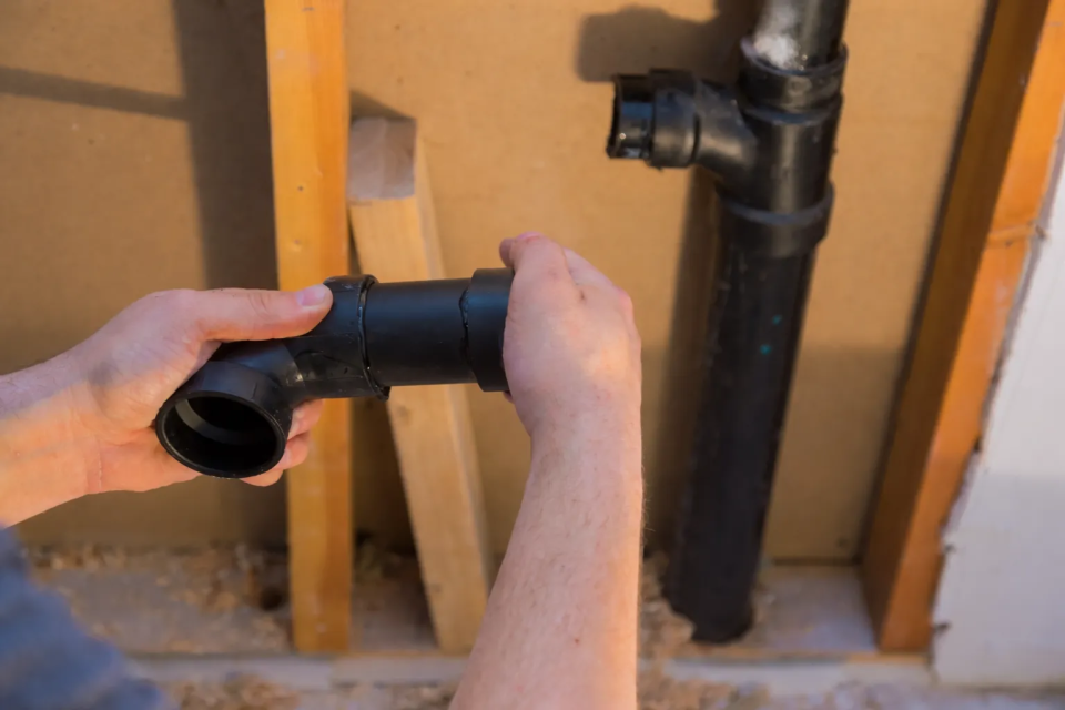 Orange County Location 2 professional drain repair services Los Angeles technician fixing damaged drain pipe inside home